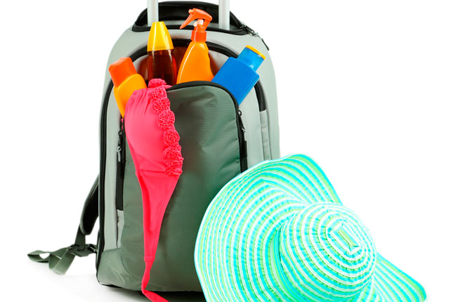 Holiday luggage with sunhat and sunlotions