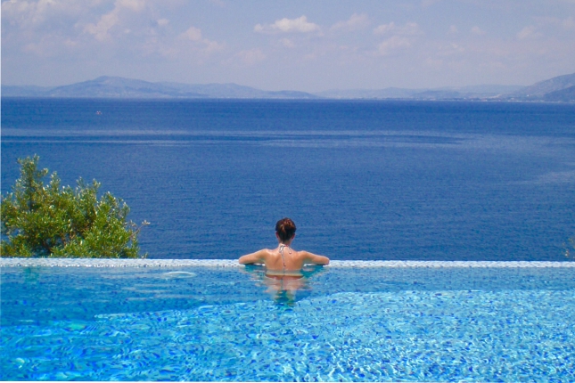 Permalink to Top 10 June summer retreats Lady in Infinity pool at Dolphins Leap, Pelion in Greece