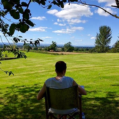 summer retreat offers: woman enjoying vast view of countryside