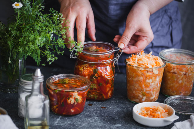 Fermentation of food in glass jars with cabbage and carrots