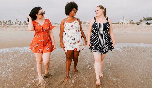 Pregnant women walking along beach